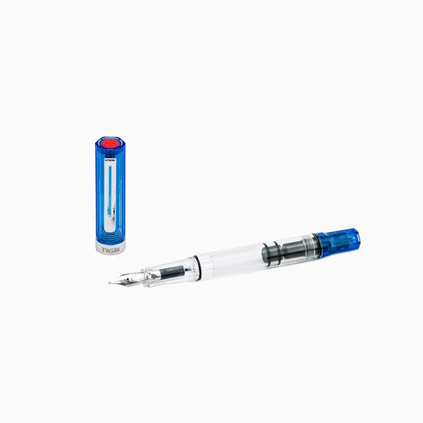Twsbi Eco transparent blue fountain pen with clear body and silver accents, showcasing its nib and ink reservoir.