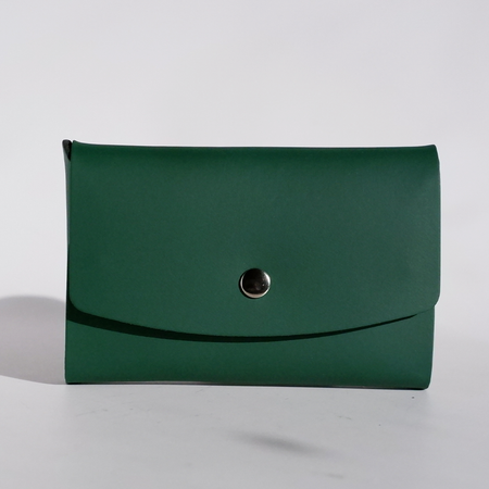Green Papier Plume Swatch Card Holder made of regenerated leather, designed for storing and organizing fabric or swatch cards.