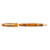 Esterbrook Estie fountain pen with gold fittings and honey-colored resin body on a honeycomb background.