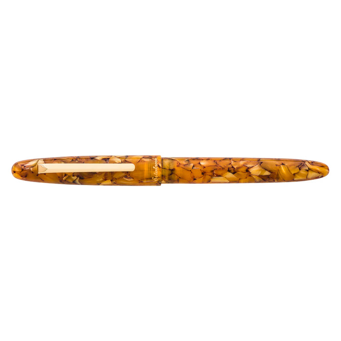 Esterbrook Estie fountain pen with gold fittings, displayed on honeycomb-patterned background, showcasing elegant design and craftsmanship.