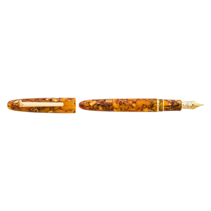 Esterbrook Estie fountain pen with gold fittings and honey-colored resin body on a honeycomb background.