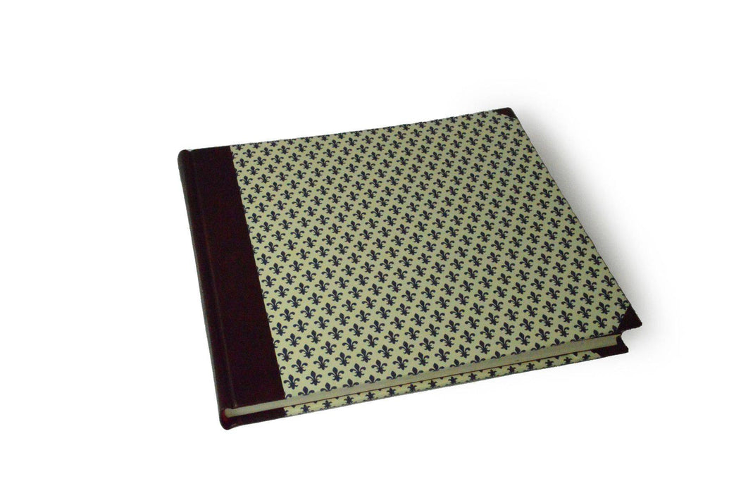 Large handcrafted guest book by Il Cartiglio with dark blue marbleized cover and leather trim, blank interior for signatures.