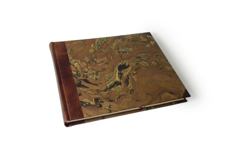 Large handcrafted guest book by Il Cartiglio with dark blue marbleized cover and leather trim, perfect for guest signatures.