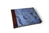 Small handcrafted guest book by Il Cartiglio with a marbleized green cover and leather trim, perfect for special events.