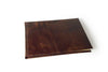Small handcrafted guest book by Il Cartiglio with a dark green marbleized cover and leather trim, perfect for special occasions.