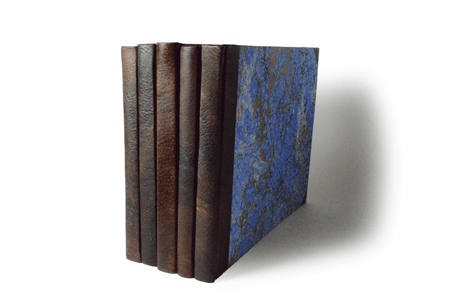 Small handcrafted guest book by Il Cartiglio with dark green marbleized cover and leather trim, ideal for special occasions.