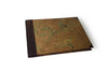 Small handcrafted guest book by Il Cartiglio with dark green marbleized cover and leather trim, ideal for special occasions.