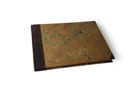 Small handcrafted guest book by Il Cartiglio with dark green marbleized cover and leather trim, ideal for special occasions.