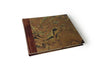 Small handcrafted guest book by Il Cartiglio with dark green marbleized cover and leather trim for special occasions.