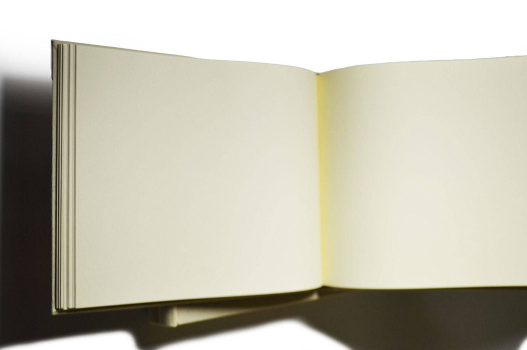 Small handcrafted Il Cartiglio guest book with off-white linen cover and elegant design, ideal for guest signatures.