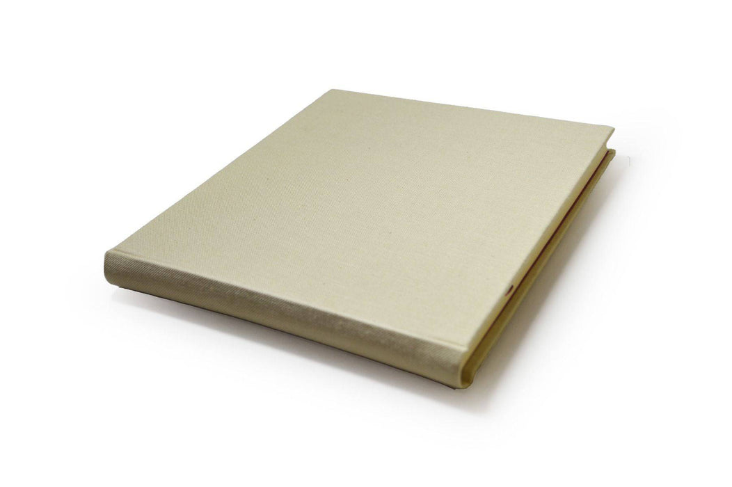 Small handcrafted Il Cartiglio guest book with off-white linen cover, featuring elegant binding and classic design.