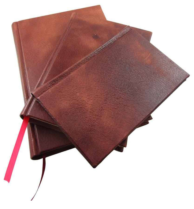 Handcrafted leather journal with a modern spine, pocket size, made by Il Cartiglio, featuring smooth leather and blank pages.