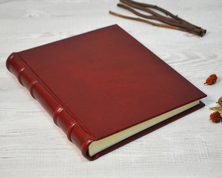 Small leather photo album by Il Cartiglio with a classic cover and space for preserving cherished photographs.