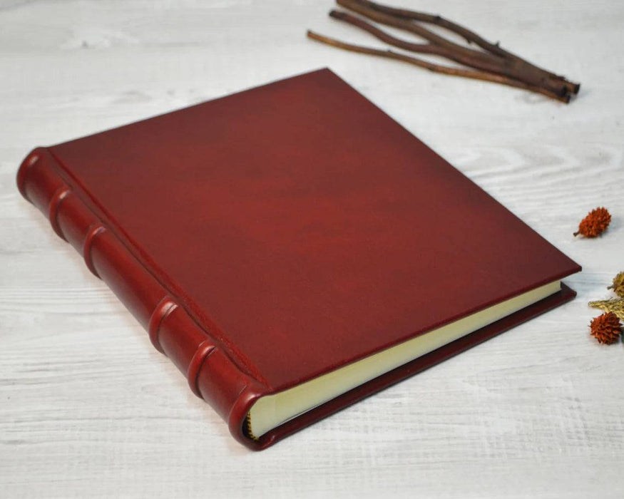 Small leather photo album by Il Cartiglio with a classic cover and space for preserving cherished photographs.