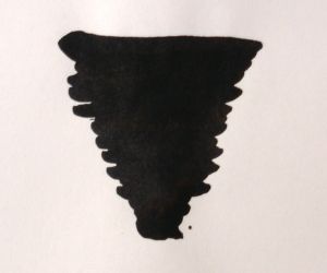Diamine bottled fountain pen ink in jet black, showing the dark ink inside the transparent glass bottle with a black cap.