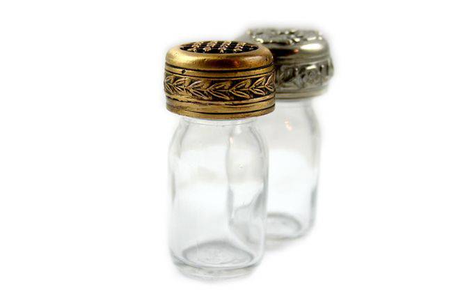 Bronze 10 ml ink bottle from Le Potier D'etain with a floral design, showcasing its elegant glass container.