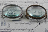 Large pewter magnifying glass on feet with circular frame by Le Potier D'etain, close-up of the detailed design.