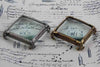Large pewter magnifying glass on square feet by Le Potier D'etain, detailed close-up of the vintage-style glass and ornate base.