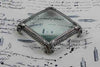 Large pewter magnifying glass on feet, square shape, by Le Potier D'etain, with a clear glass lens and decorative base.