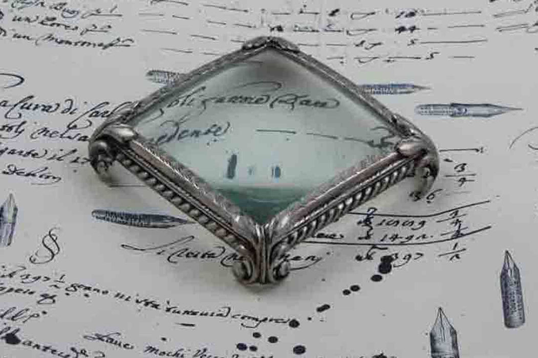 Large pewter magnifying glass on feet, square shape, by Le Potier D'etain, with a clear glass lens and decorative base.