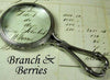 Large pewter magnifying glass with handle featuring a branch and berries design, by Le Potier D'etain.
