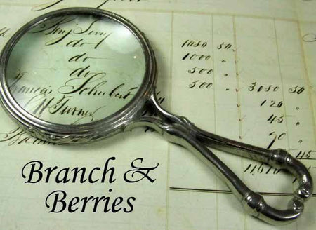 Large pewter magnifying glass with handle featuring a branch and berries design, by Le Potier D'etain.