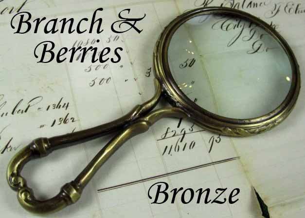 Large Le Potier D'etain magnifying glass with handle featuring a branch and berries design in pewter.