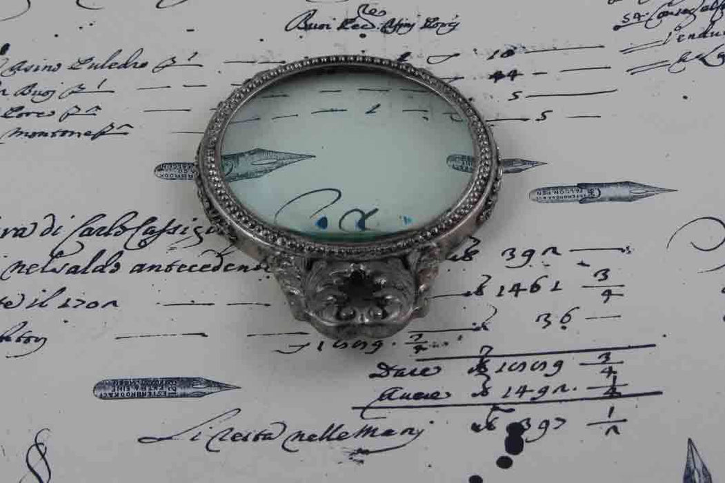 Large Le Potier D'etain magnifying glass with handle, featuring detailed acanthus design in pewter, ideal for close inspection.