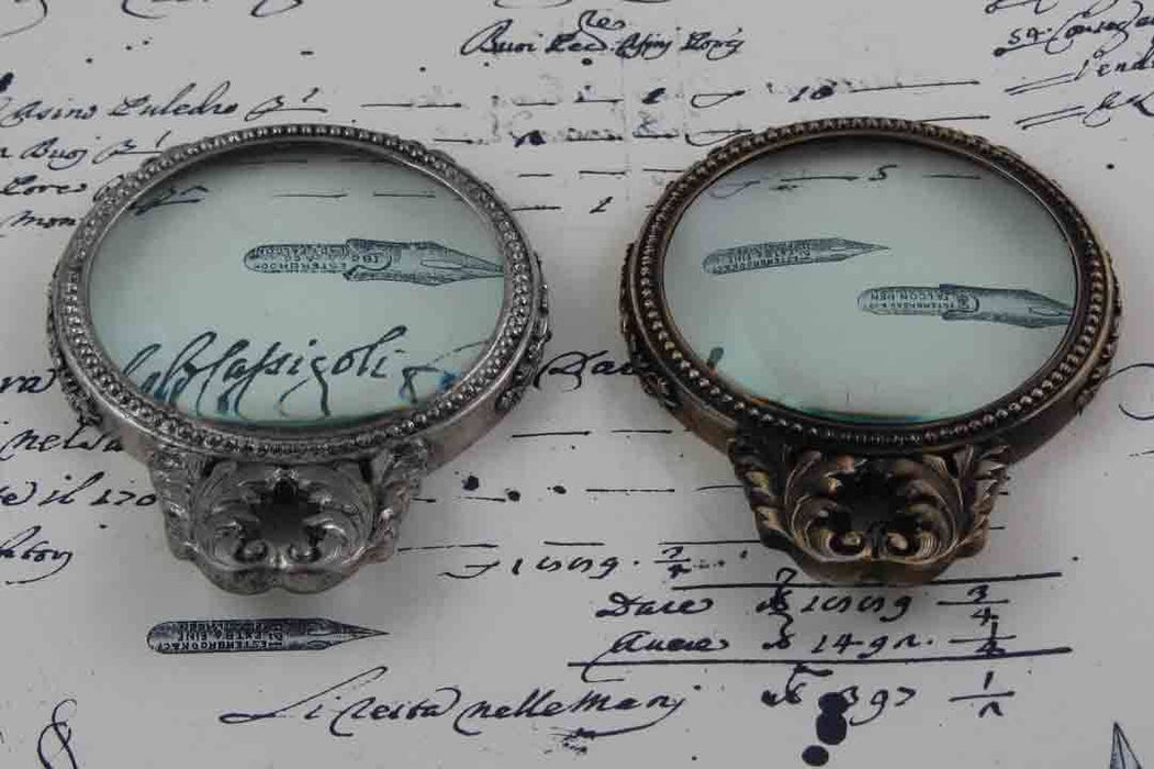 Le Potier D'Etain large pewter magnifying glass with handle and acanthus design for detailed viewing.