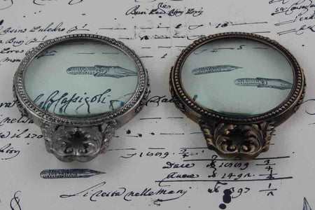 Le Potier D'Etain large pewter magnifying glass with handle and acanthus design for detailed viewing.