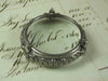 Small pewter magnifying glass on feet with fleur de lys design by Le Potier D'etain, detailed antique-style magnifier.