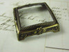 Small Le Potier D'etain pewter magnifying glass on square feet, decorative and functional magnifier for close-up viewing.