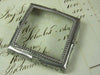 Small pewter magnifying glass on feet, square-shaped by Le Potier D'etain, with detailed craftsmanship and vintage design.