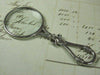 Small pewter magnifying glass with handle featuring a fleur de lys design, by Le Potier D'etain.