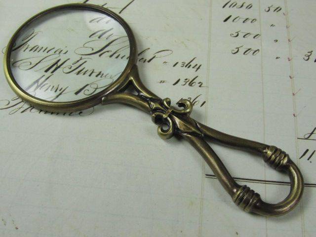 Small pewter magnifying glass with handle featuring a Fleur de Lys design by Le Potier D'etain.