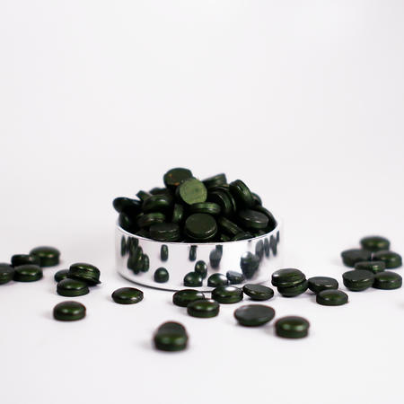Moss green Papier Plume wax beads in a jar, natural and glossy, ideal for candle making and craft projects.