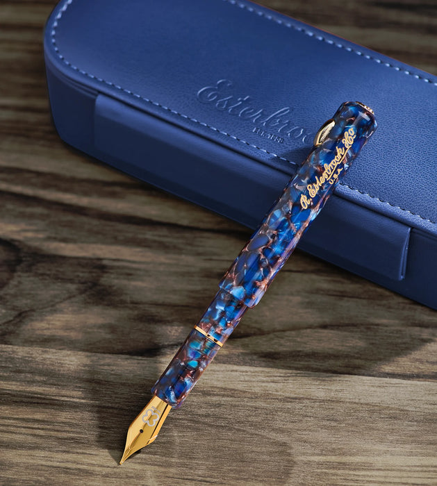 Esterbrook Niblet fountain pen with a sleek black body and gold accents, showcasing the pen's nib and elegant design.