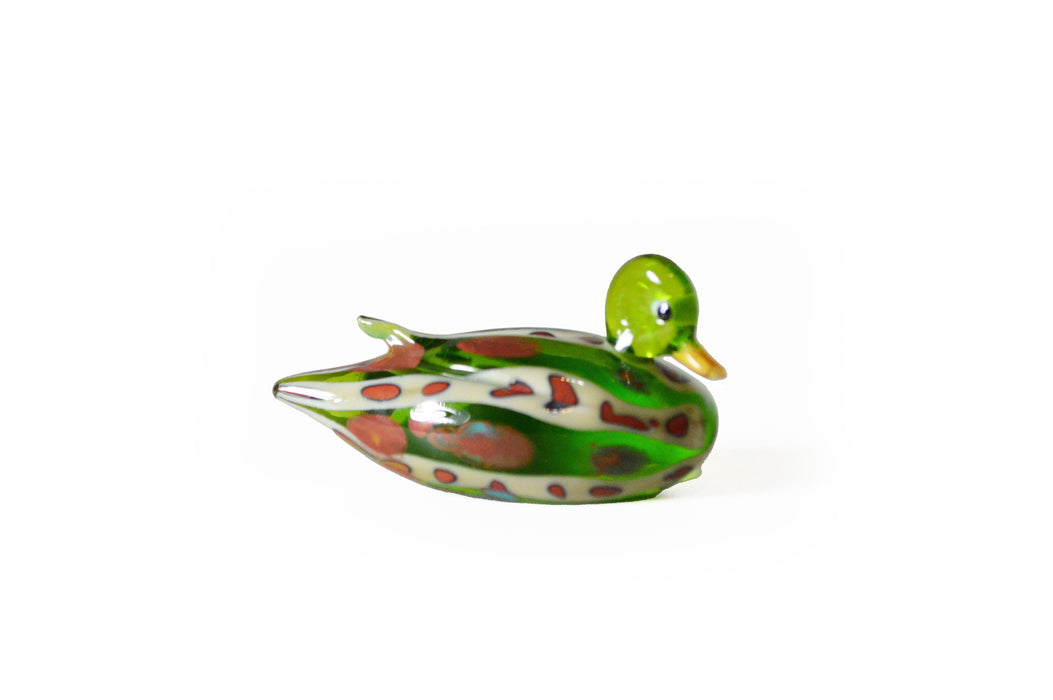 No Solo Vetro glass duck pen rest in purple, decorative and functional desk accessory for holding pens and writing tools.