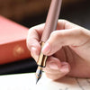 Otto Hutt Design 06 Seashell Pink fountain pen with an elegant, slim body and gold accents, showcasing its fine nib and stylish design.