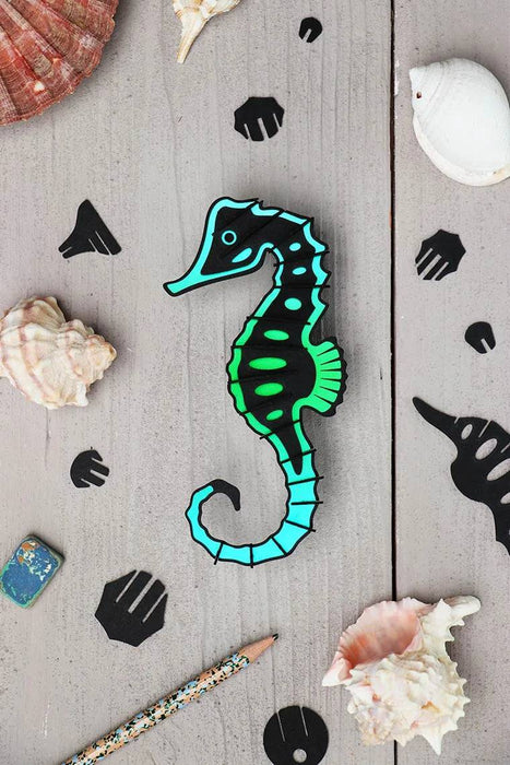 Assembli Paper Seahorse craft made from Caribbean green metallic paper, showcasing a detailed seahorse design.