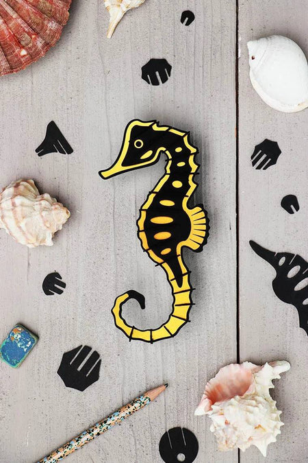 Crafts paper seahorse by Assembli made from Caribbean green metallic paper, showcasing detailed, colorful origami-style sea creature.