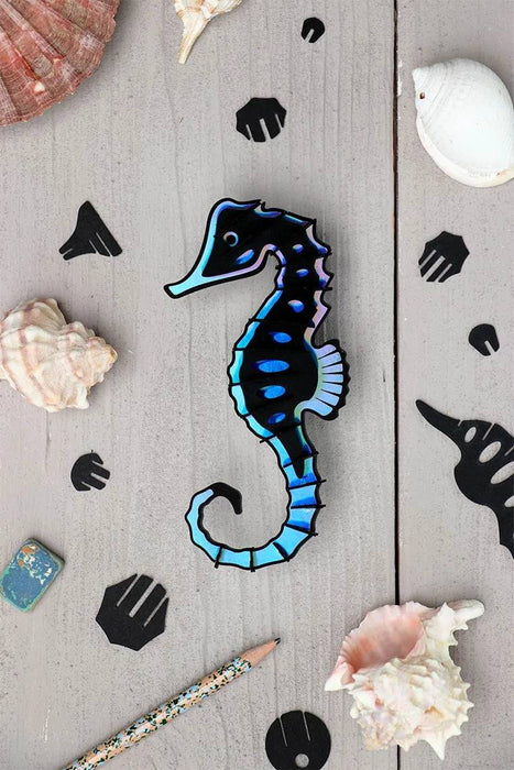 Assembli Paper Seahorse craft made from Caribbean green metallic paper with intricate details and textured fins.