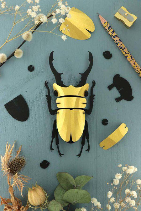 Small paper stag beetle craft by Assembli in Caribbean green metal paper, showcasing detailed insect design.
