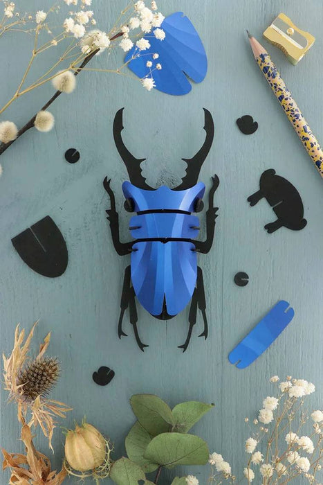 Small Papier Plume Crafts paper stag beetle in Caribbean green metal finish by Assembli, showcasing detailed insect design.
