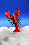 Paper craft lobster from Assembli, featuring detailed red lobster design with textured paper and intricate craftsmanship.