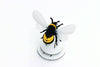 Craft paper Bumble Bee by Assembli, featuring yellow and black paper wings and body for DIY craft projects.