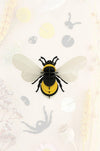 Colorful paper bumble bee craft by Assembli featuring yellow and black paper with detailed wings and antennae.