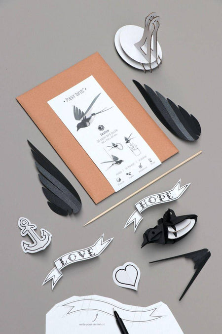 Paper Swallow craft by Assembli featuring a delicate paper swallow sculpture on a neutral background.