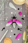 Emerald green metallic Paper Firefly craft made with Assembli's Papier Plume craft paper, showcasing a detailed firefly design.
