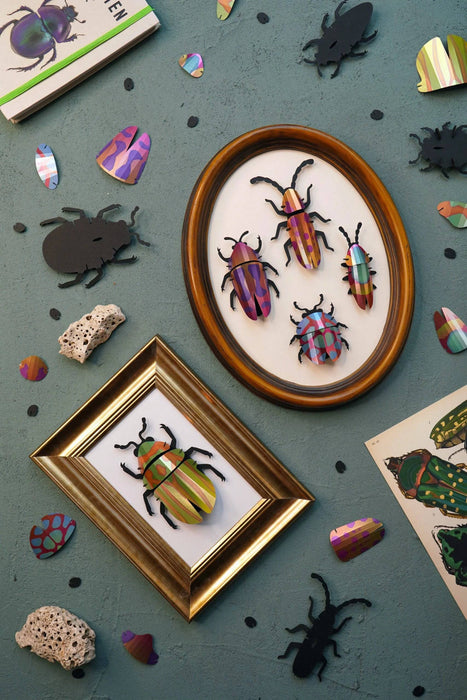 Green paper beetle craft from Assembli's Paper Beetle Collection, featuring detailed textured paper wings and body.